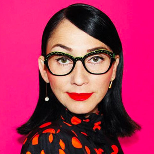 Portrait of Rose Apodaca, A+R co-founder, against a bright pink background