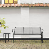 Black metal Vig Dining Bench with wireframe backrest and armrests, paired with matching black stool on brick patio.