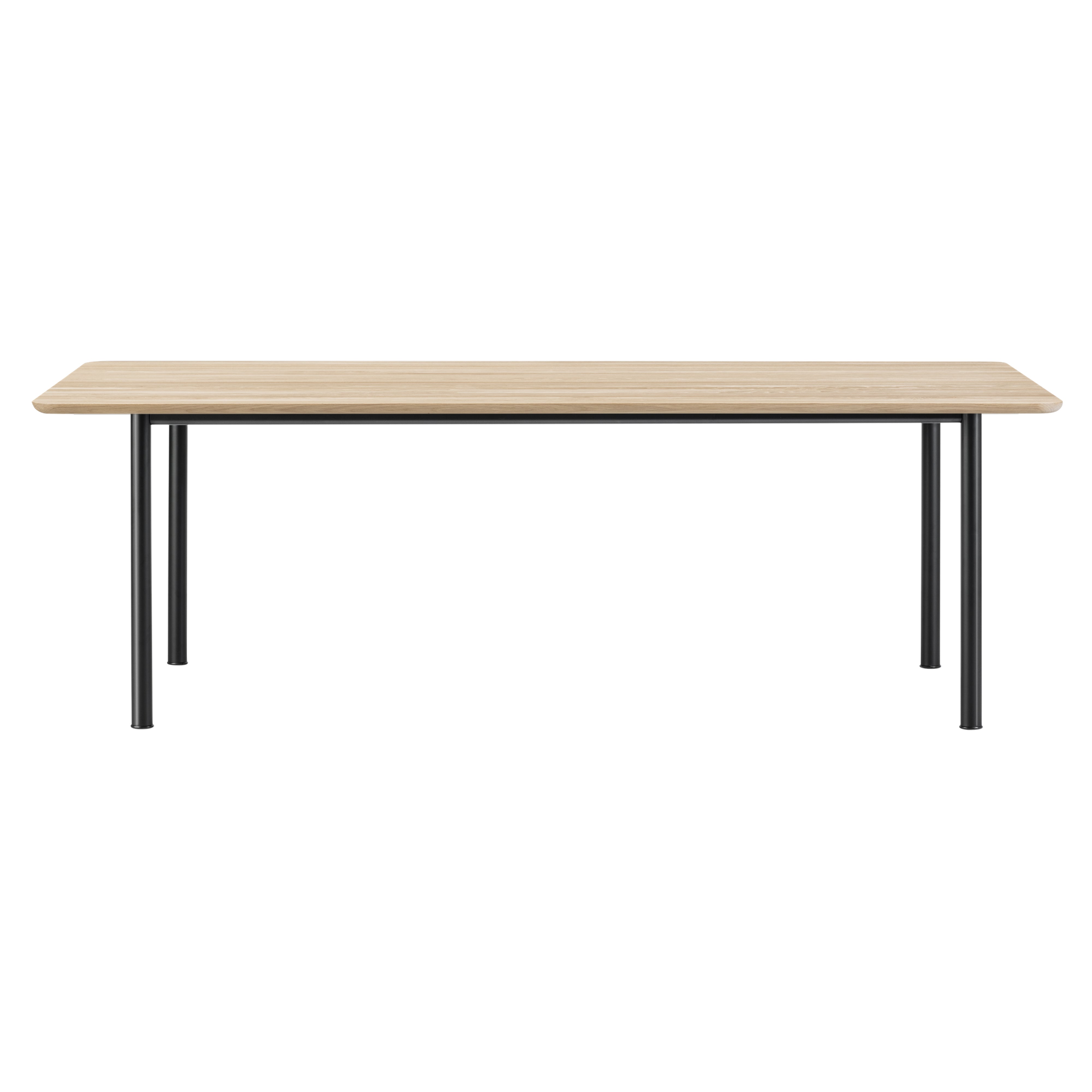 A rectangular dining table with a light oak top, rounded corners and four slim black tubular legs