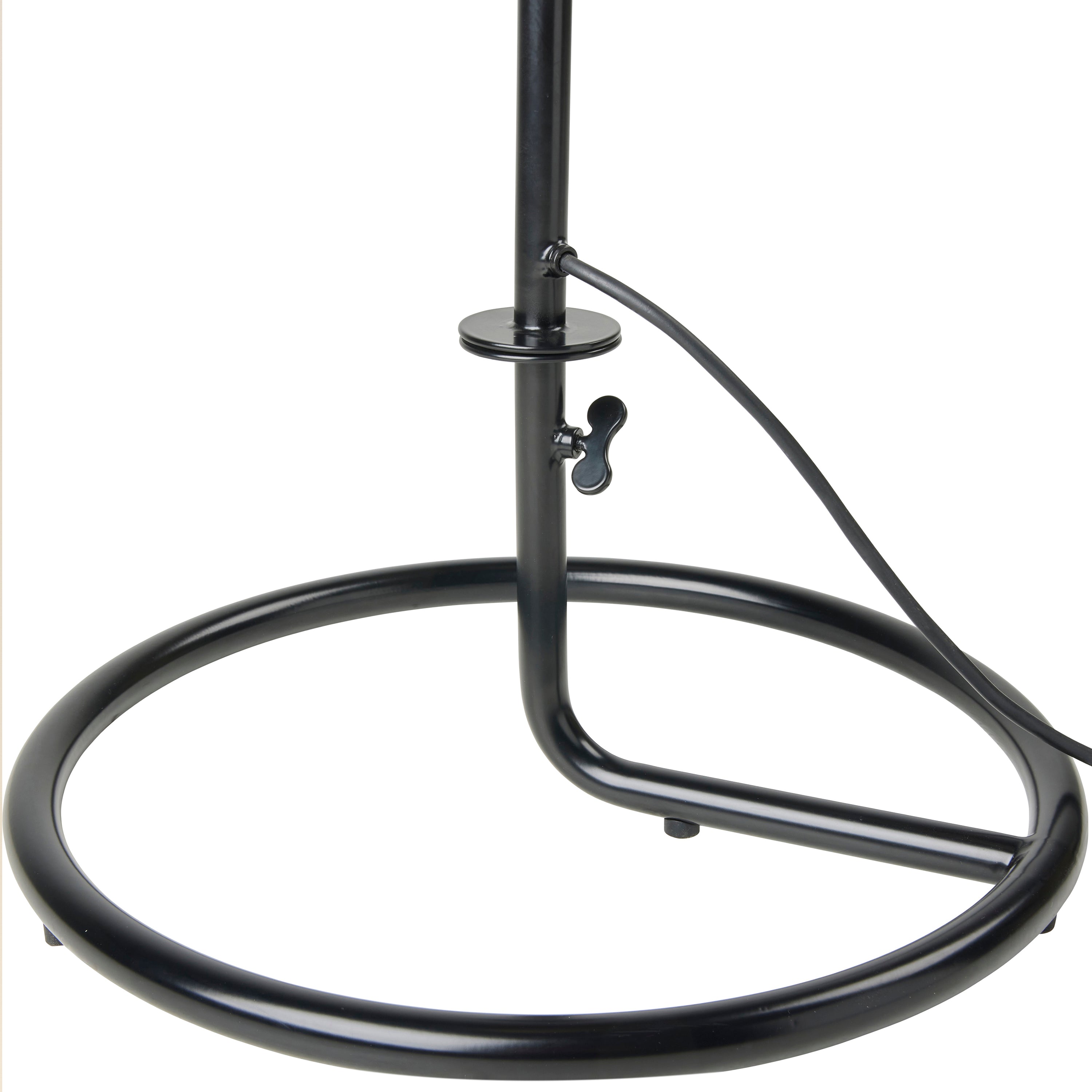 Close-up of a black metal lamp base, a round tubular ring with an upright pole, wing screw and cord