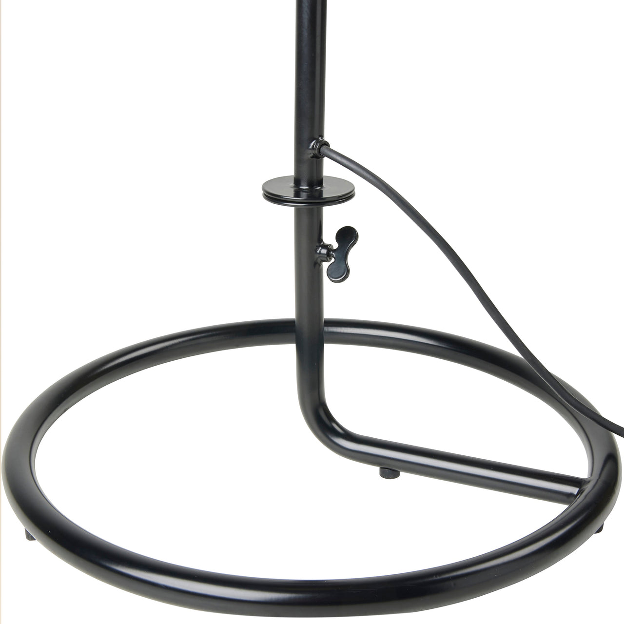 Close-up of a black metal lamp base, a round tubular ring with an upright pole, wing screw and cord