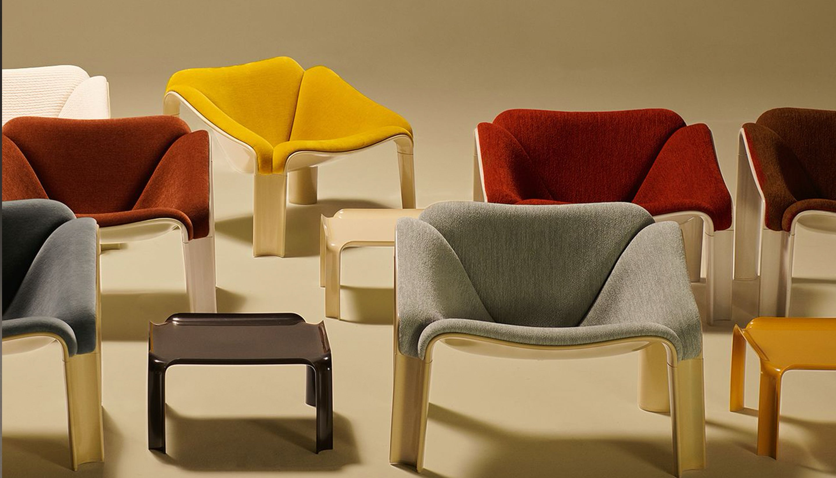 Modern chairs in various colors on a neutral background
