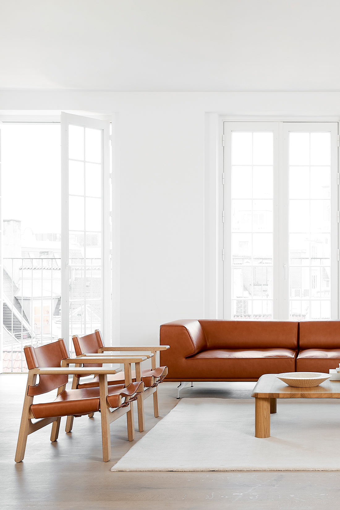 Brown leather furniture in white livingroom