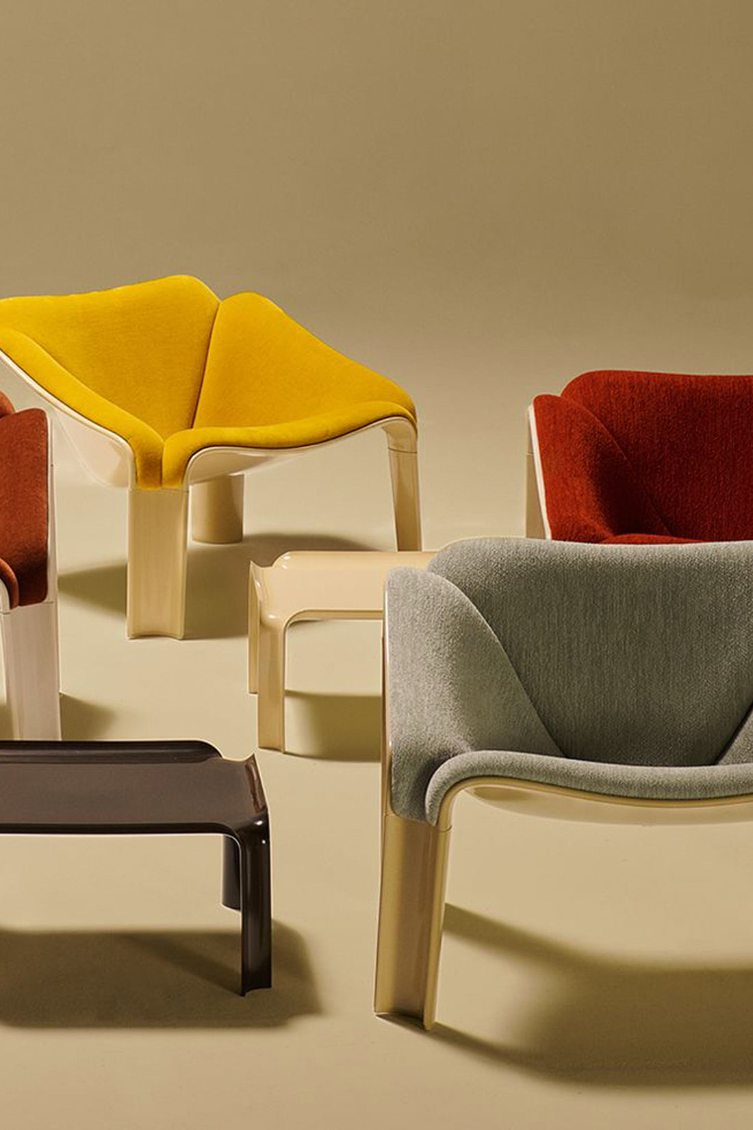 Modern chairs with colorful cushions on a beige background