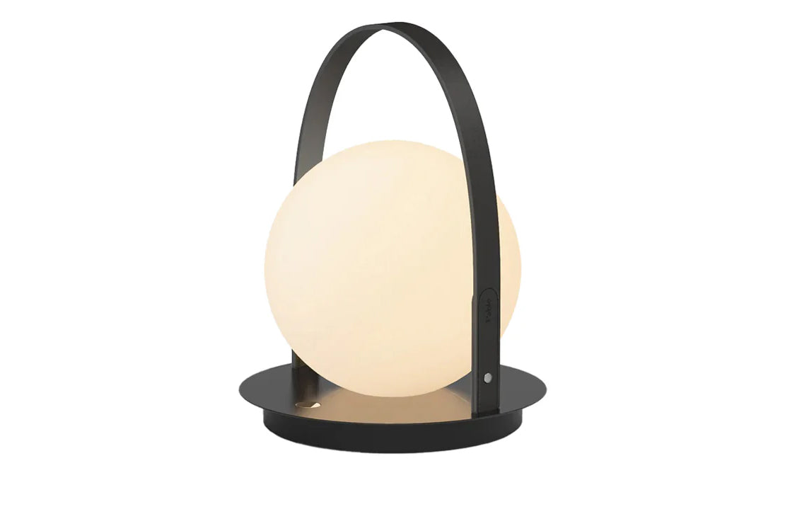 Table lamp with a round white shade and black metal base on a white background