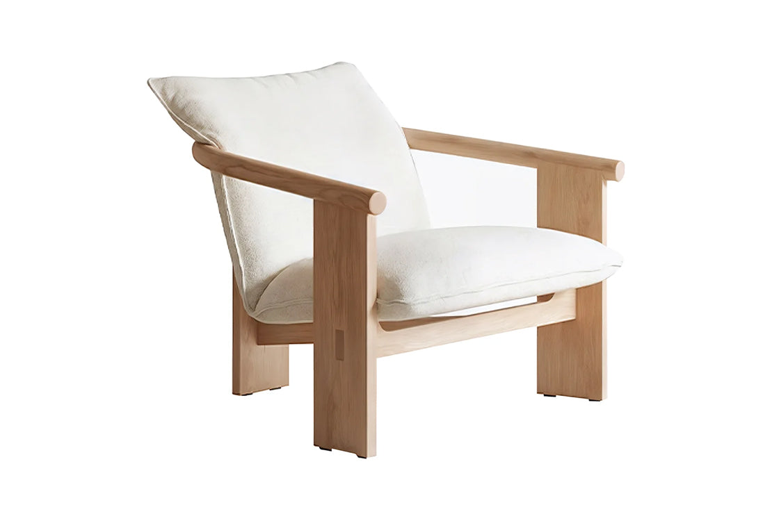 A modern wooden armchair with a light natural wood frame and thick, plush off-white cushions, shown against a solid white background.