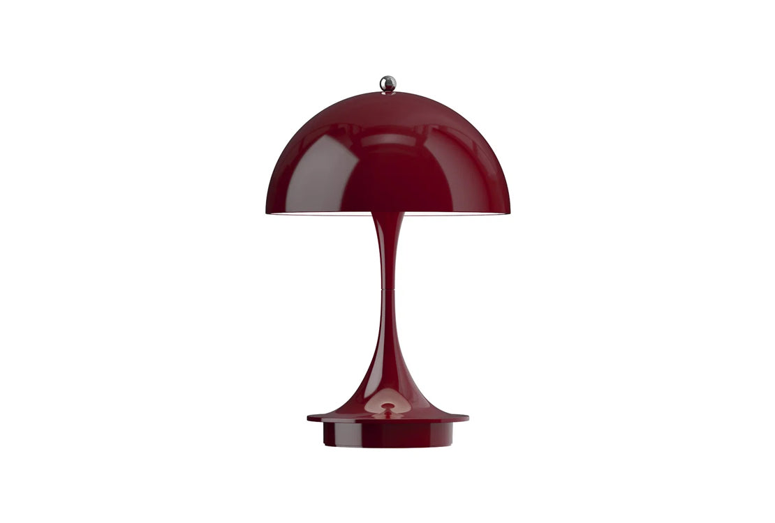 A glossy deep burgundy table lamp with a dome-shaped shade and a curved pedestal base, centered on a plain white background.