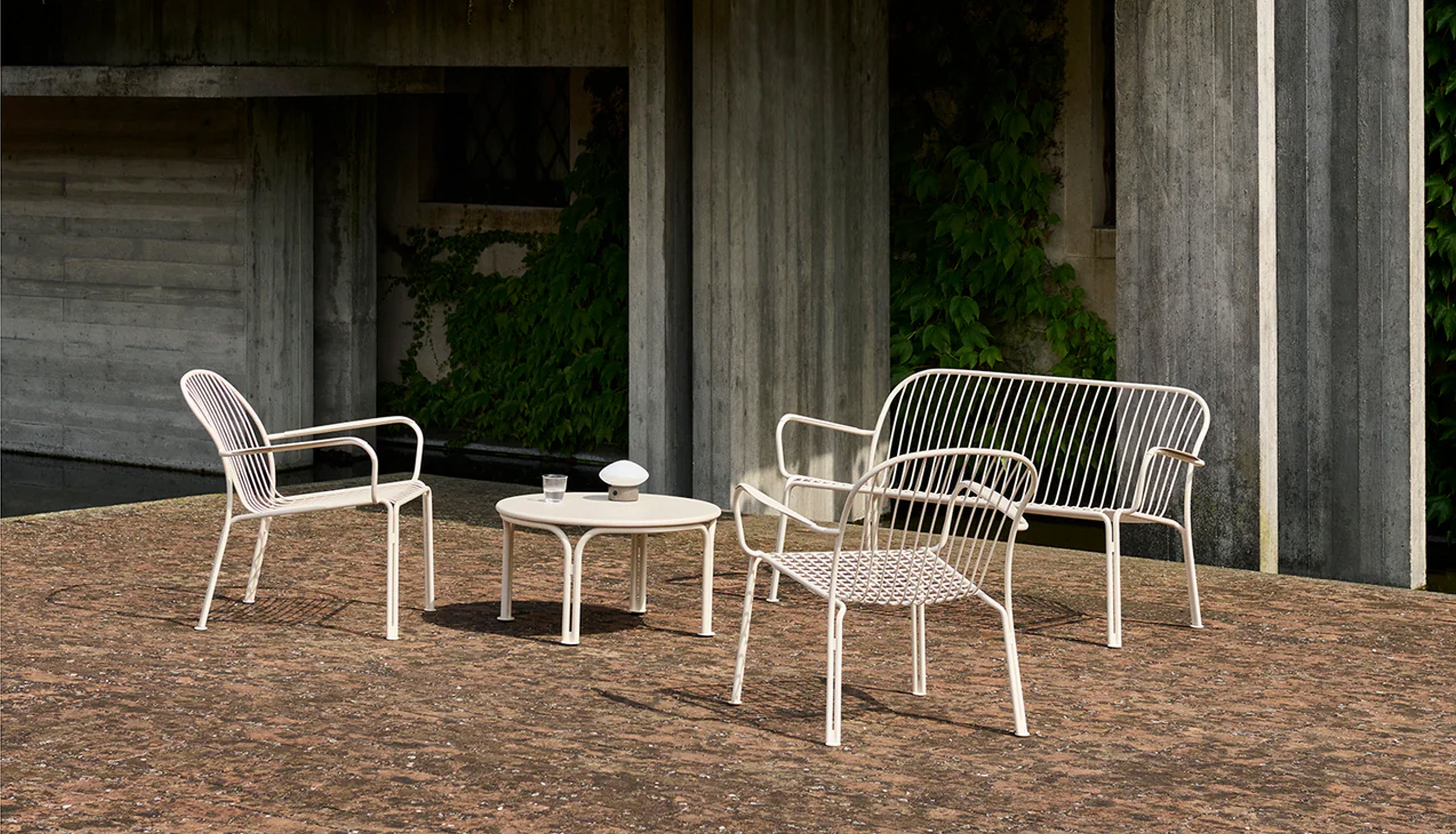 White outdoor patio set in a concrete setting