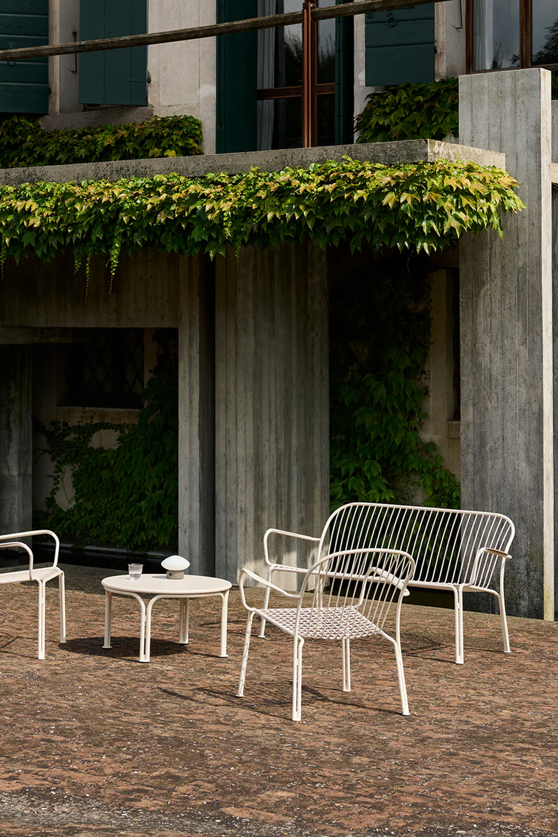 White outdoor patio set in a concrete setting