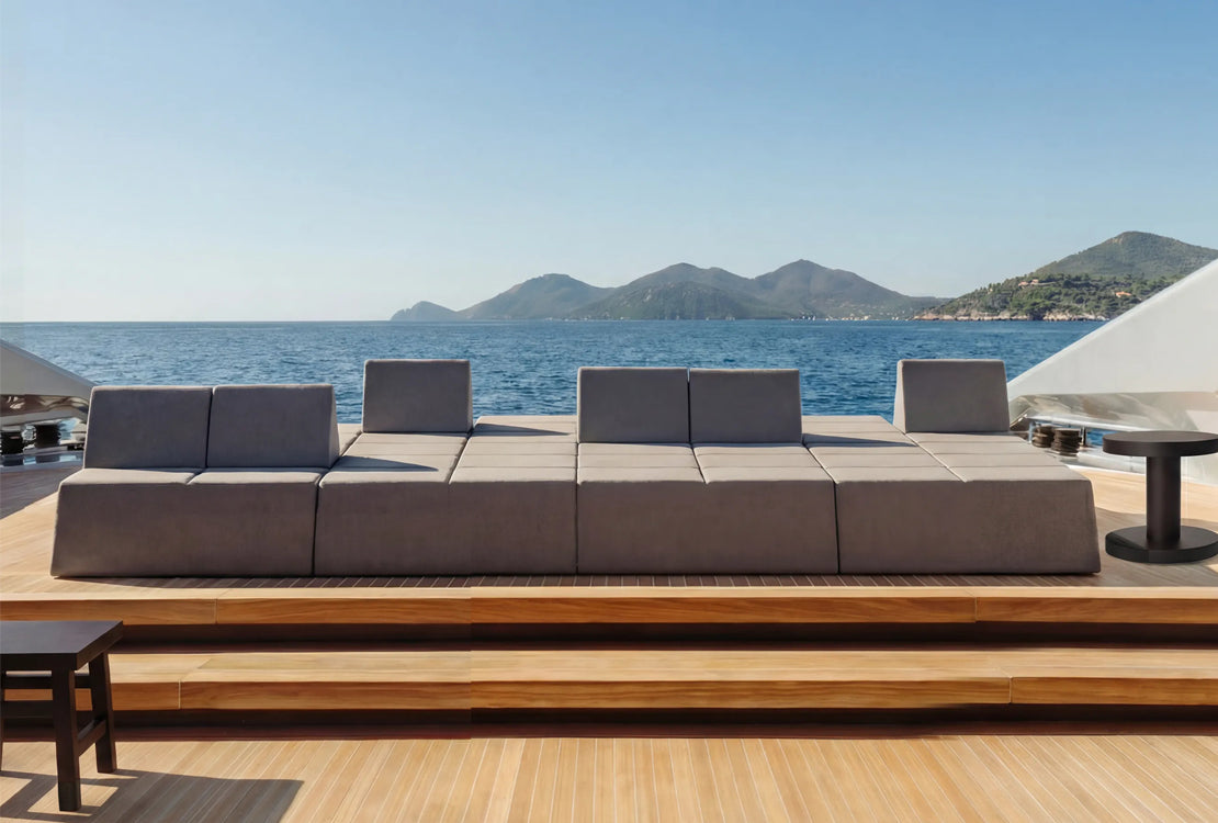Modular outdoor cushion set on deck against ocean