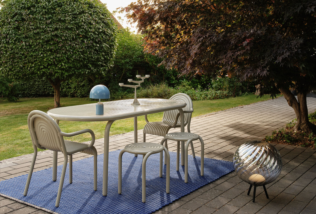 Outdoor patio set with table and chairs on a wooden deck