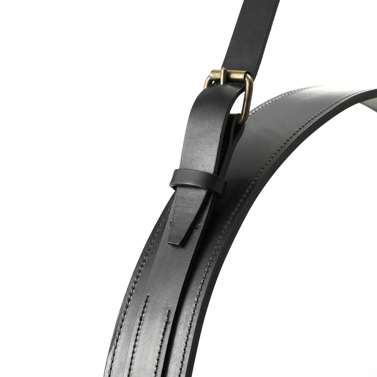 Close-up of a black stitched leather mirror frame with a hanging strap and brass buckle