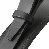 Close-up of a black leather strap with a stitched edge threaded through a small leather loop