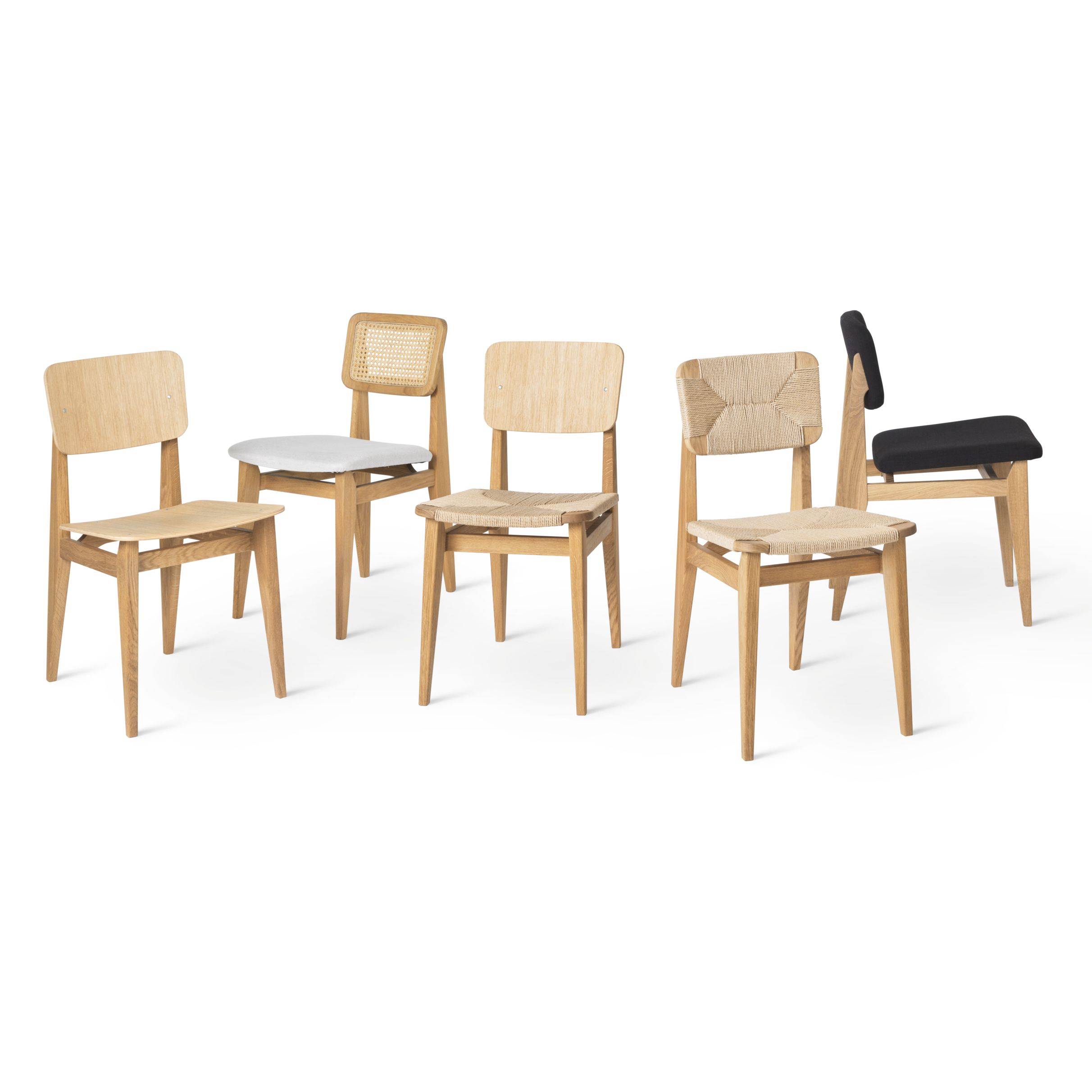 Five light oak dining chairs with different seats and backs: wood, cane, woven paper cord, grey and black fabric