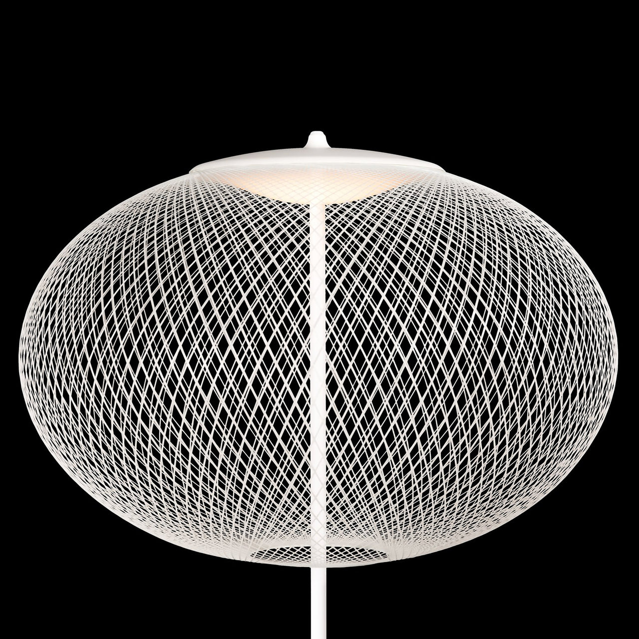 A white floor lamp with a wide oval shade of fine crisscrossing wire, lit from above, on black